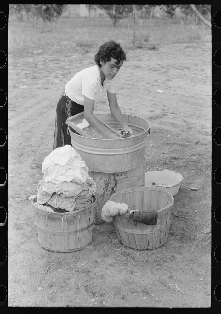 Daughter of Spanish-American farmer washing, Chamisal, New Mexico by Russell Lee