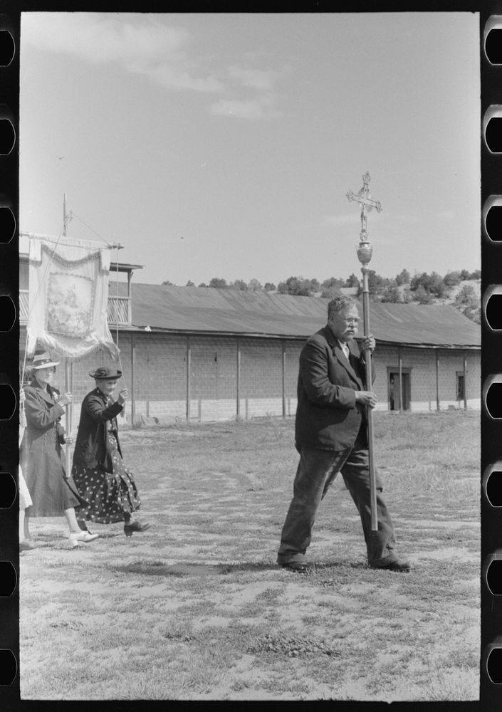 Spanish-American man leading the Catholic procession held in honor of a saint. Penasco, New Mexico by Russell Lee