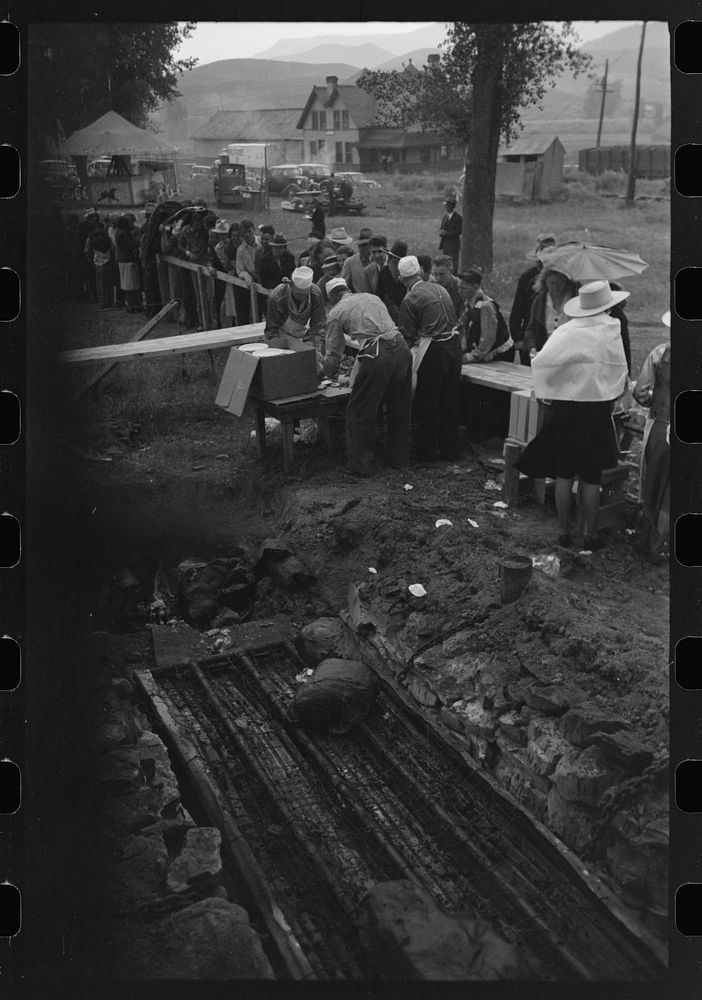 [Untitled photo, possibly related to: Barbecue pits and people standing in line to be served at the free barbecue at Labor…