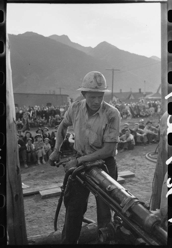 Gold miner operating hand drill in hand-drilling contest on Labor Day, Silverton, Colorado by Russell Lee