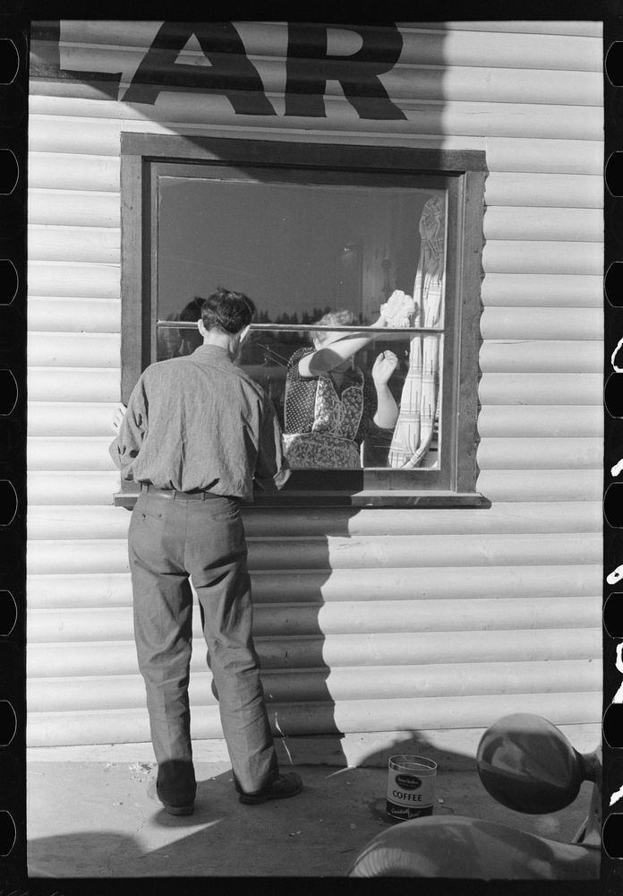Washing windows of bar. Central Valley, California by Russell Lee
