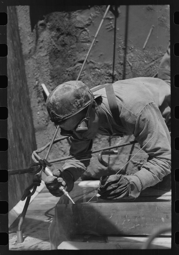 Spot welder at work on Shasta Dam. Shasta County, California by Russell Lee