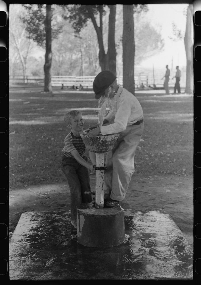 Fun at the water fountain, picnic grounds, Vale, Oregon by Russell Lee