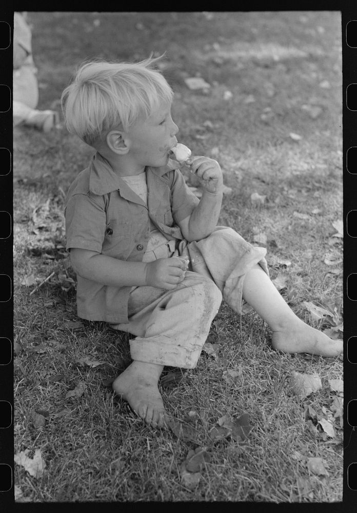 Little boy enjoys his ice cream, Fourth of July, Vale, Oregon by Russell Lee