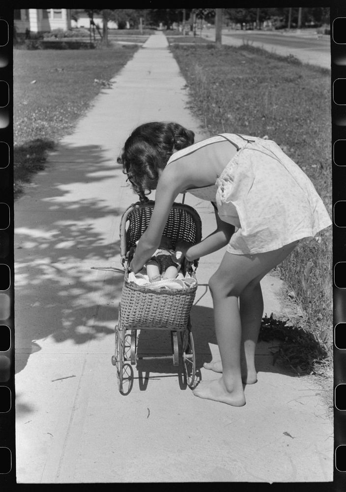 Little girl plays with her doll. Caldwell, Idaho by Russell Lee