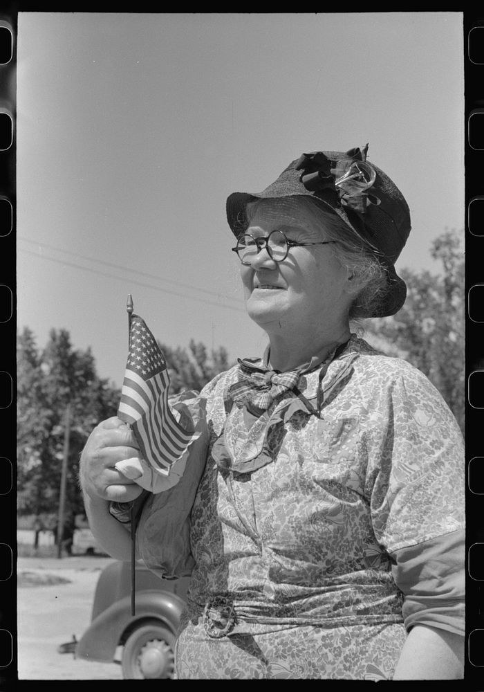 She has been shopping and bought a flag for the Fourth of July. Caldwell, Idaho by Russell Lee