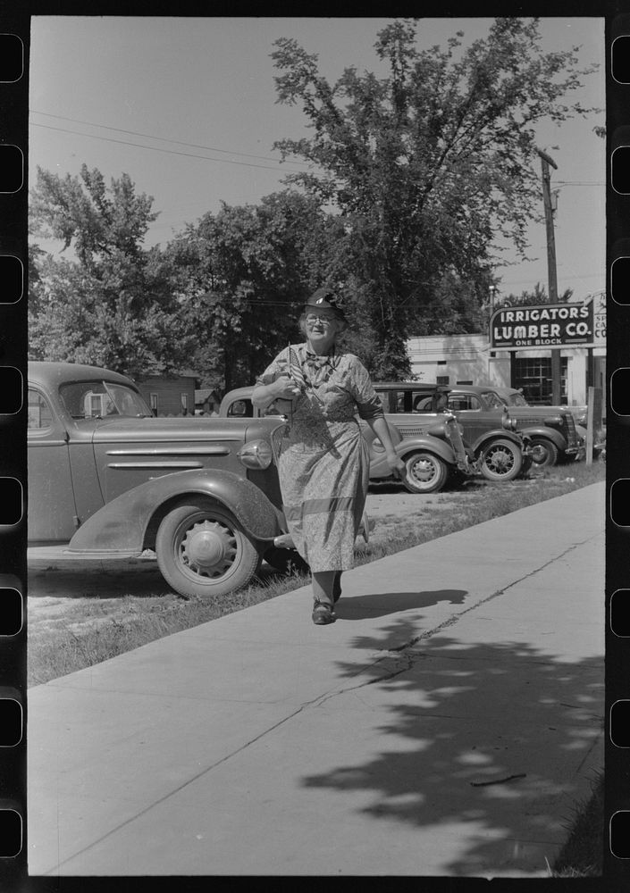 [Untitled photo, possibly related to: She has been shopping and bought a flag for the Fourth of July. Caldwell, Idaho] by…