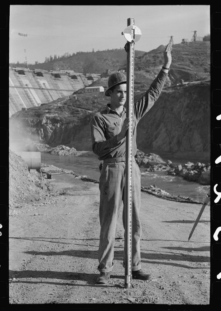 Rod man with surveying crew at Shasta Dam, Shasta County, California by Russell Lee