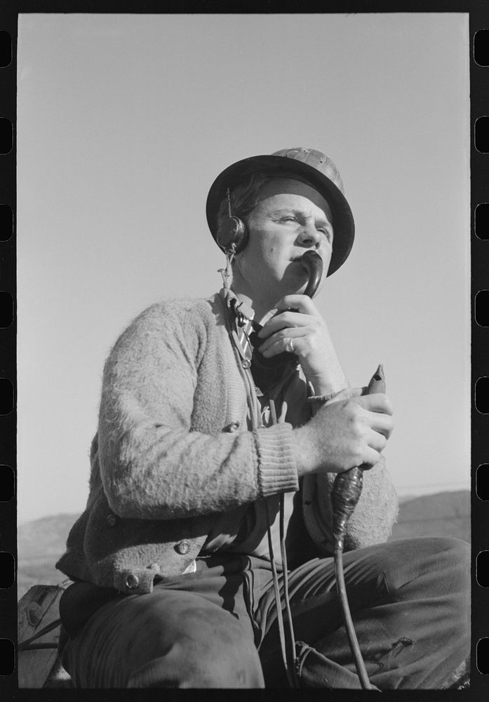 [Untitled photo, possibly related to: Signal man at Shasta Dam, Shasta County, California. He telephones to crew at central…