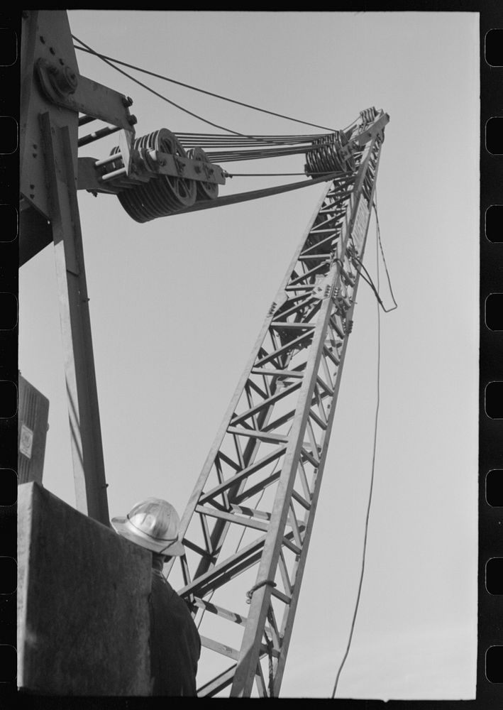 [Untitled photo, possibly related to: Crane on top of central tower for handling repairs of carriage of buckets which…