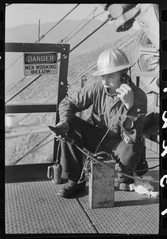 [Untitled photo, possibly related to: Workman keeps in touch with various construction points by telephone at Shasta Dam…