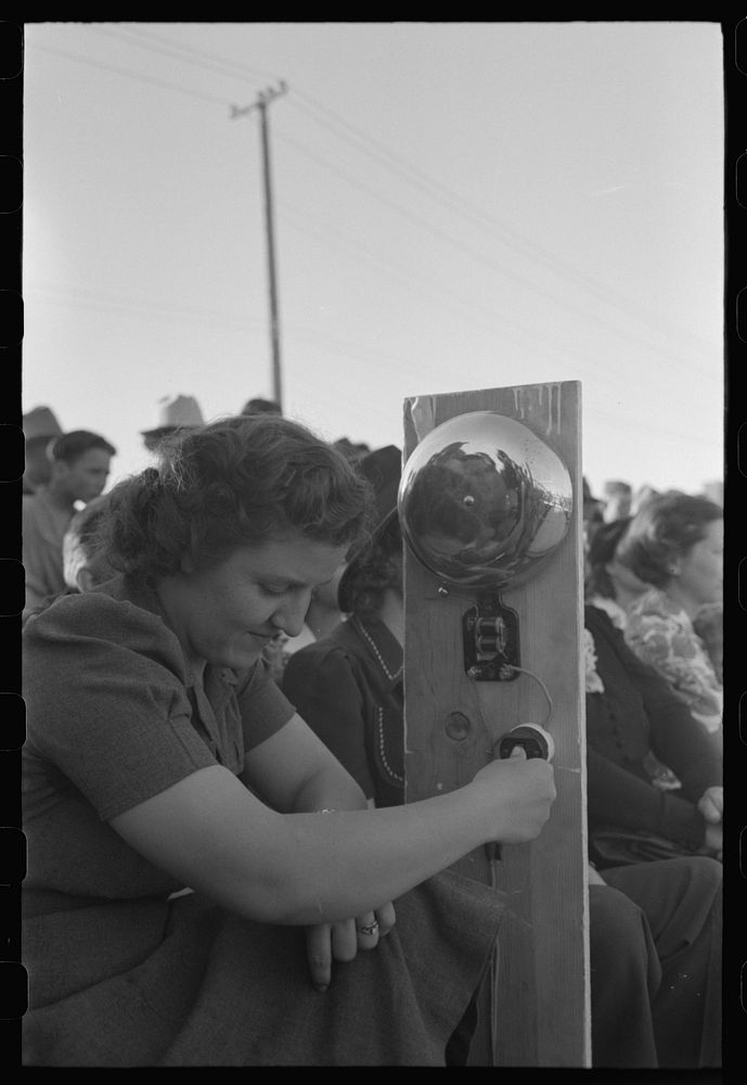 Ringing gong at boxing match at the annual field day of the FSA (Farm Security Administration) farmworkers community, Yuma…