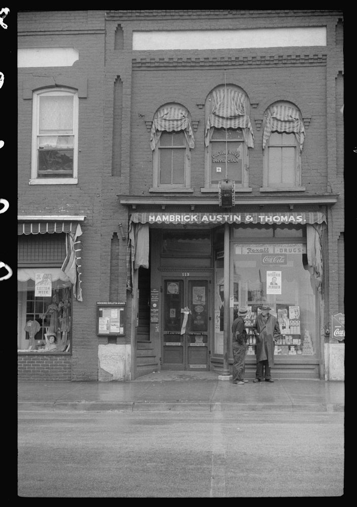 es standing on the corner of the main street on rainy Memorial Day.  Roxboro, North Carolina. Sourced from the Library of…