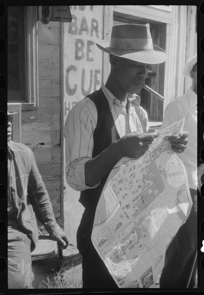 [Untitled photo, possibly related to: Granville Clarke, Florida migratory agricultural worker studying road map before…
