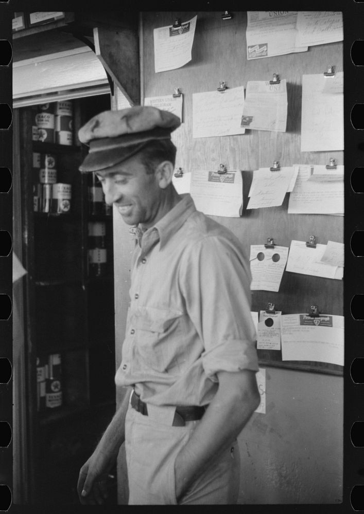 Truck driver in front of bulletin board in a truck service station on U.S. 1 (New York Avenue) in Washington, D.C.. Sourced…