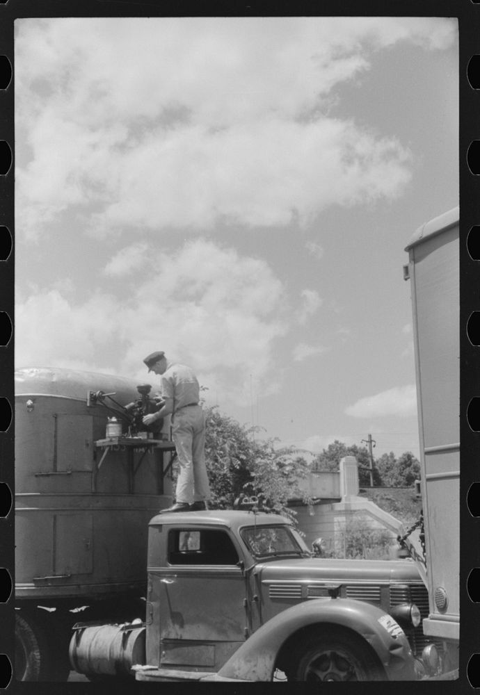 [Untitled photo, possibly related to: Starting up the motor of a refrigerator truck at a truck service station on U.S. 1…