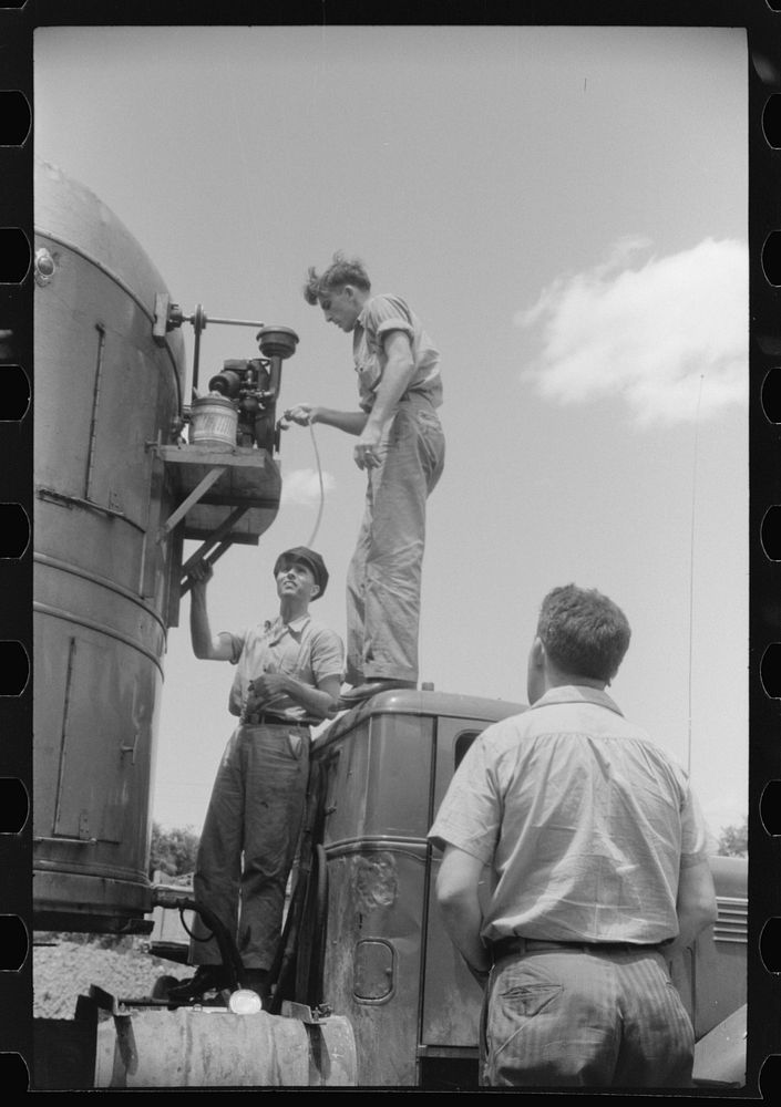 Starting up the motor of a refrigerator truck at a truck service station on U.S. 1 (New York Avenue), Washington, D.C..…