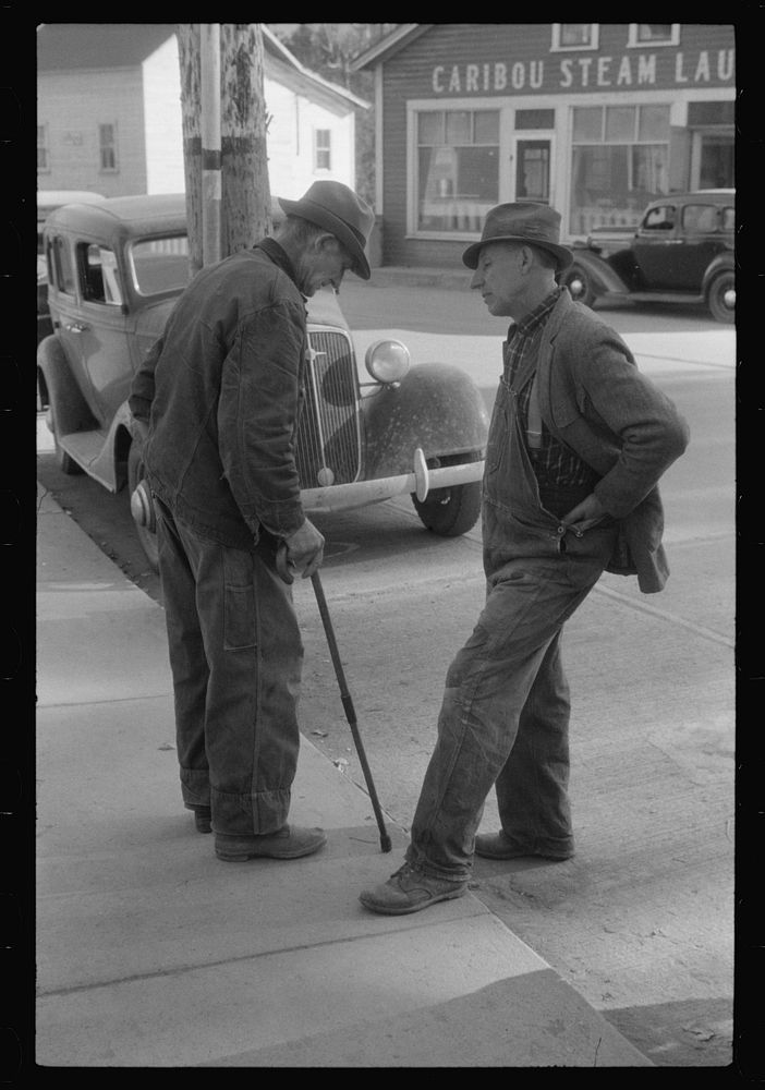 [Untitled photo, possibly related to: Two potato farmers in town Saturday afternoon in Caribou, Maine]. Sourced from the…