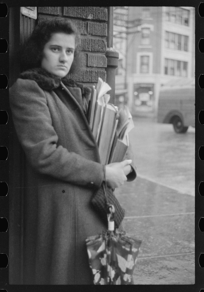 [Untitled photo, possibly related to: Young school girl waiting for a bus on a rainy day in Norwich, Connecticut]. Sourced…