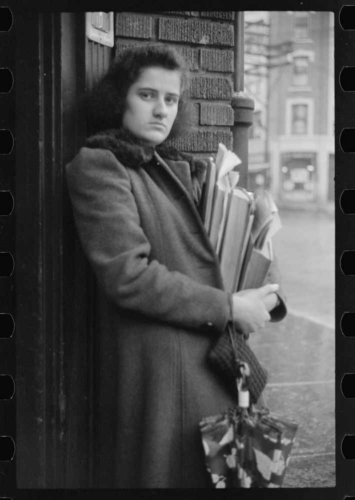 [Untitled photo, possibly related to: Young school girl waiting for a bus on a rainy day in Norwich, Connecticut]. Sourced…