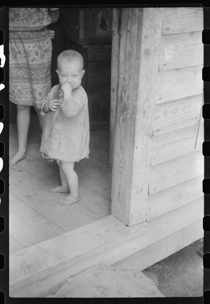 [Untitled photo, possibly related to: Youngest child of William Corneal, farmer who must move out of the area being taken…