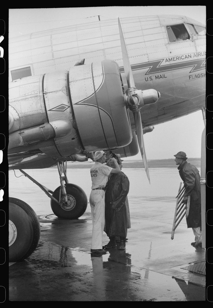 [Untitled photo, possibly related to: Ground crew assistants leaving a plane about to take off at the municipal airport in…