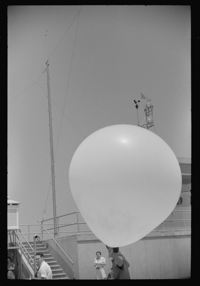 [Untitled photo, possibly related to: Preparing to send up the weather balloon at the weather bureau at the municipal…