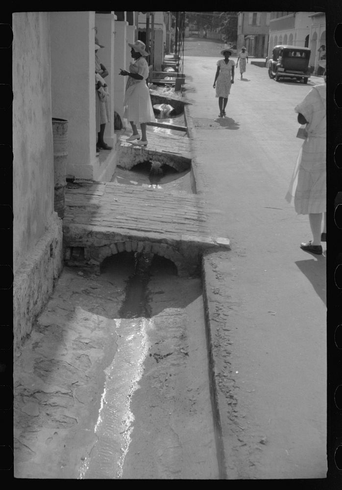 An open sewer on one of the main streets in Christiansted, Virgin Islands. Sourced from the Library of Congress.