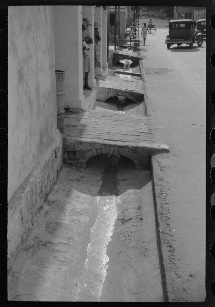 [Untitled photo, possibly related to: An open sewer on one of the main streets in Christiansted, Virgin Islands]. Sourced…
