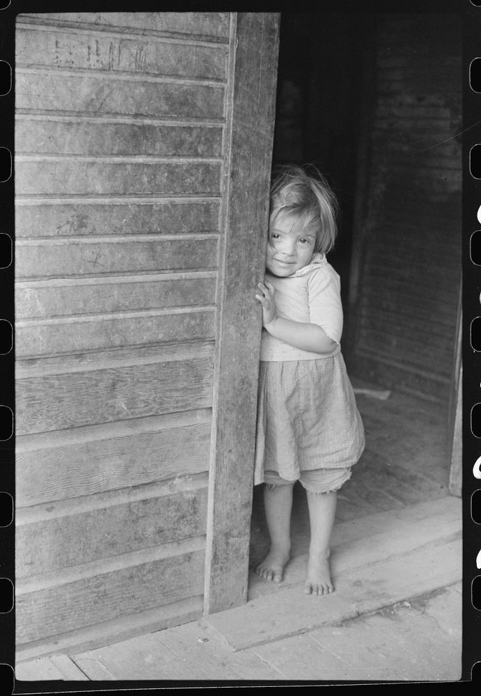 Mexican miner's child in doorway of home, Bertha Hill, West Virginia. Sourced from the Library of Congress.