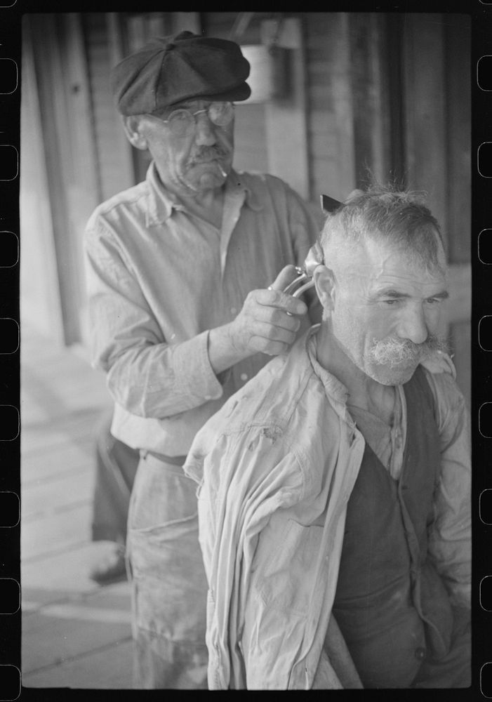 [Untitled photo, possibly related to: Miners often give haircuts on front porch. The "Patch," Chaplin, West Virginia].…