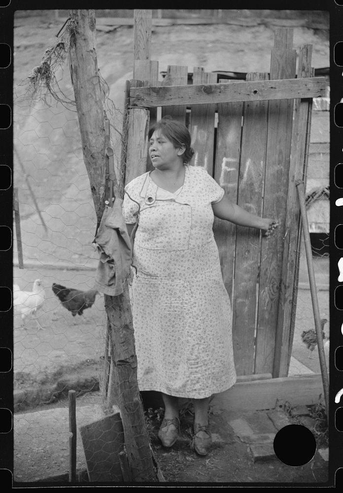 [Untitled photo, possibly related to: Mexican miner's wife and child are visited by another miner's wife (Hungarian) who is…