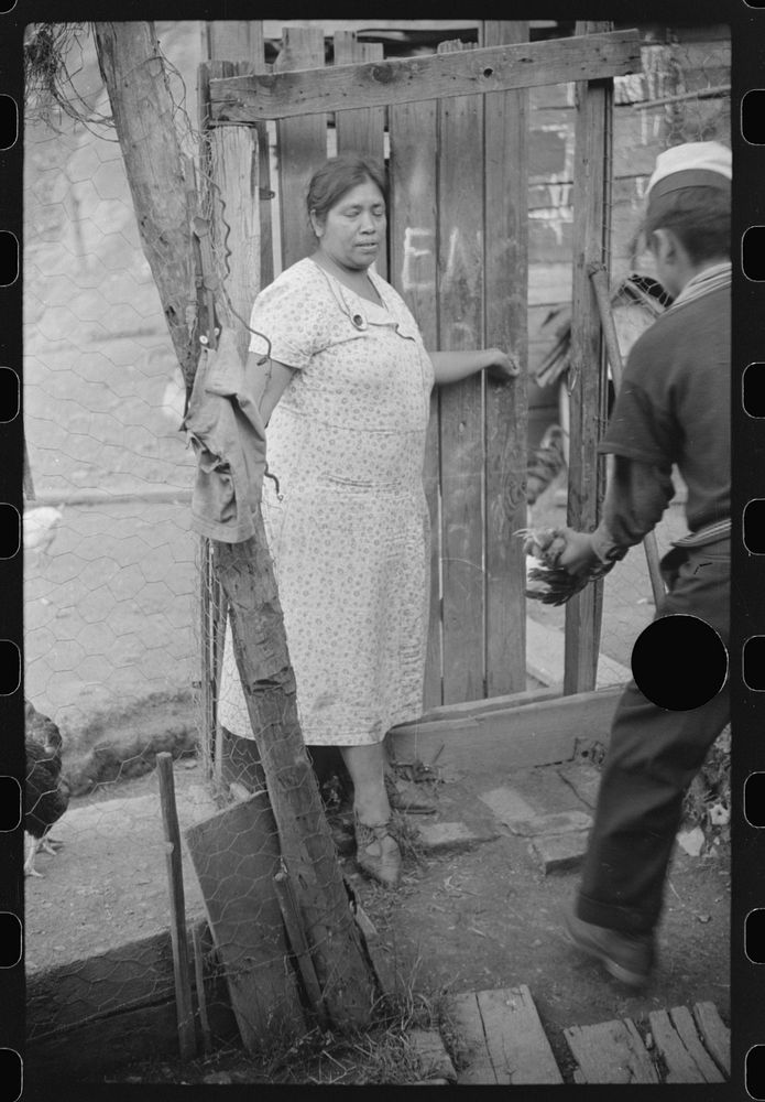 [Untitled photo, possibly related to: Mexican miner's wife and child are visited by another miner's wife (Hungarian) who is…