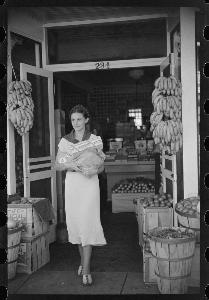 Shopper coming out of grocery store, Lakeland, Florida. Sourced from the Library of Congress.