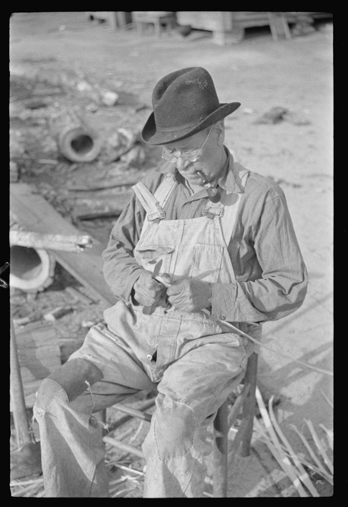[Untitled photo, possibly related to: Mixed-breed Indian, white and , near Pembroke Farms, making new chair seat. North…