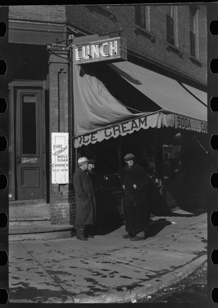 [Untitled photo, possibly related to: Townspeople of Woodstock, Vermont, discussing the severe winter on the street corner…