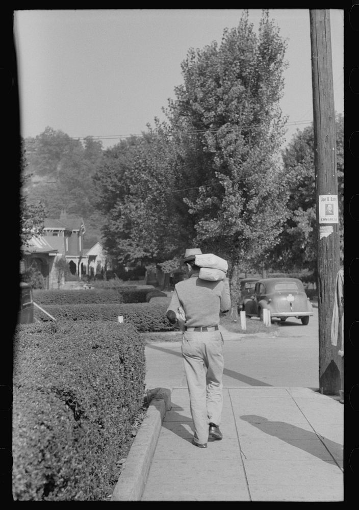 Man carrying home supplies on Saturday afternoon, Jackson, Kentucky. Sourced from the Library of Congress.