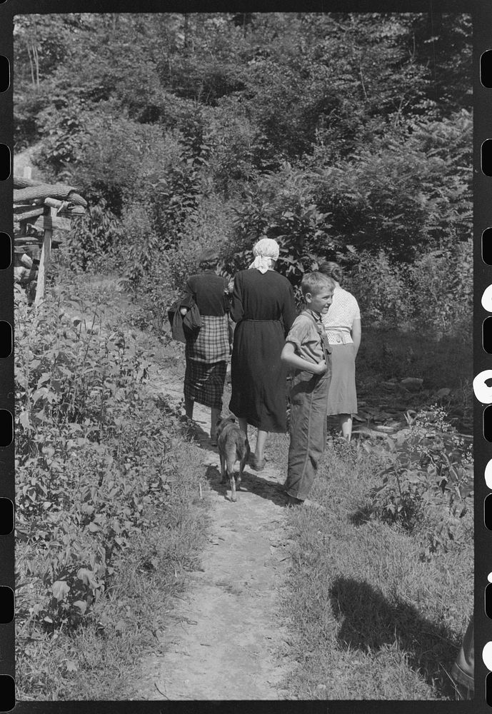 [Untitled photo, possibly related to: Mountain people carrying a homemade coffin up creek bed to the family plot on the…