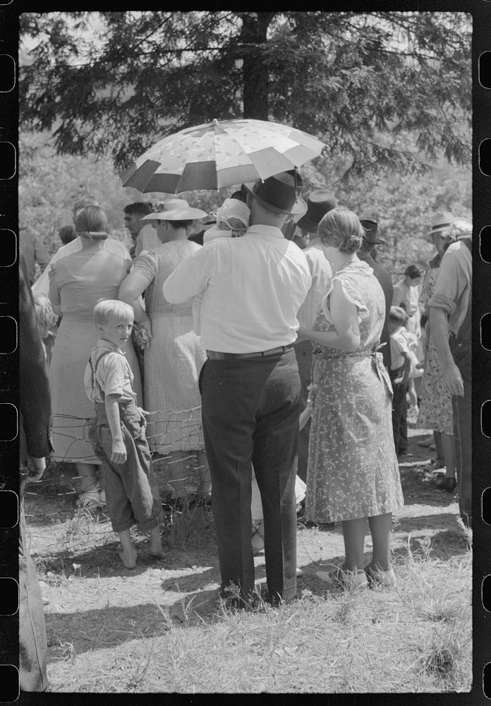 Mountain people leaving the Primitive Baptist Church in Morehead, Kentucky, and going down to the creek for a baptizing.…