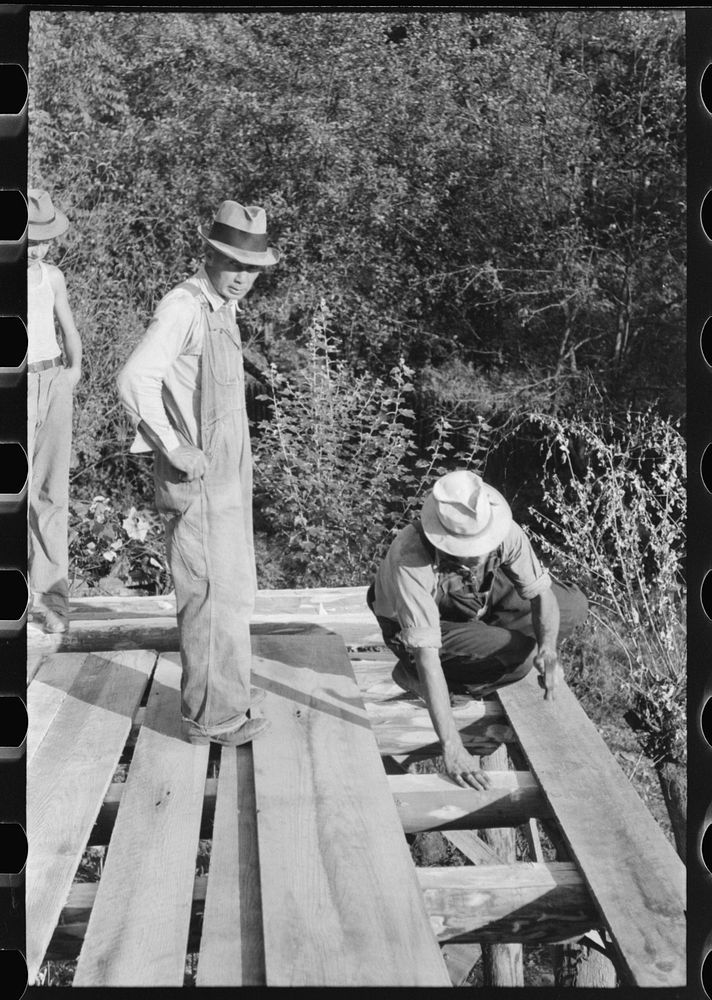 [Untitled photo, possibly related to: Mountaineer laying the new floor in his neighbor's home near Jackson, Breathitt…