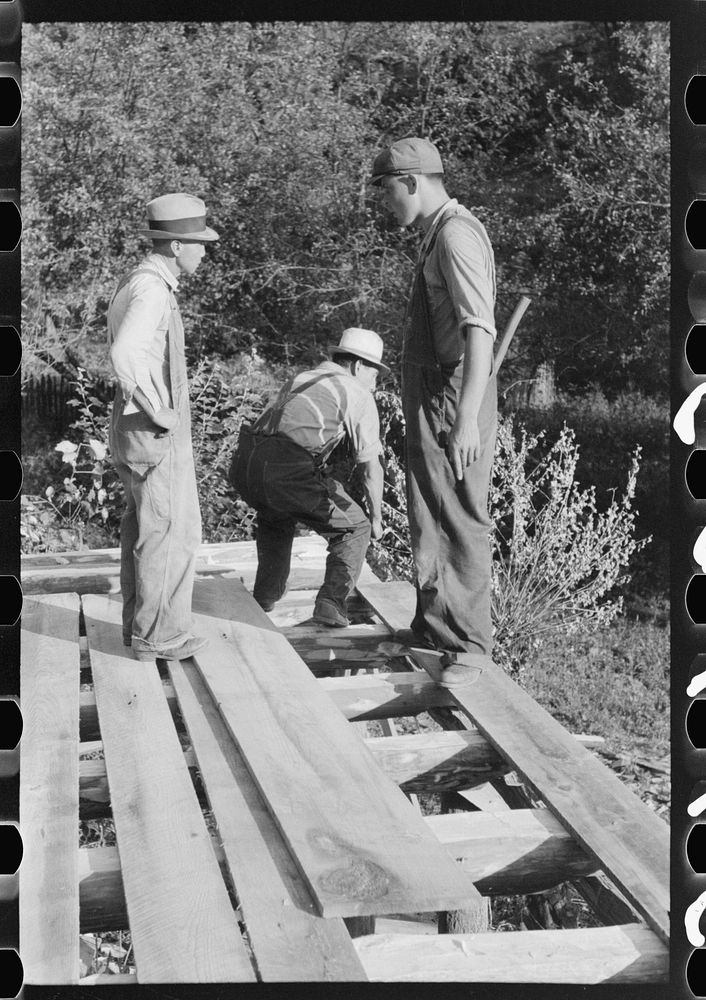 [Untitled photo, possibly related to: Mountaineer laying the new floor in his neighbor's home near Jackson, Breathitt…