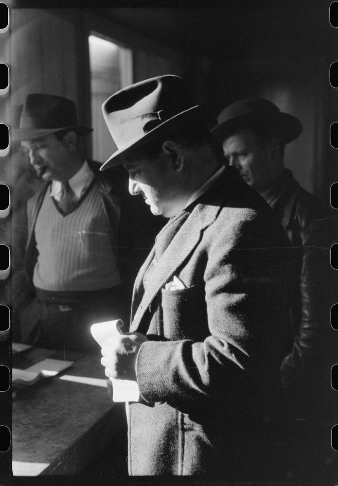 Fur buyer from New Orleans waiting for FSA (Farm Security Administration) supervisor to open the bids at auction sale of…