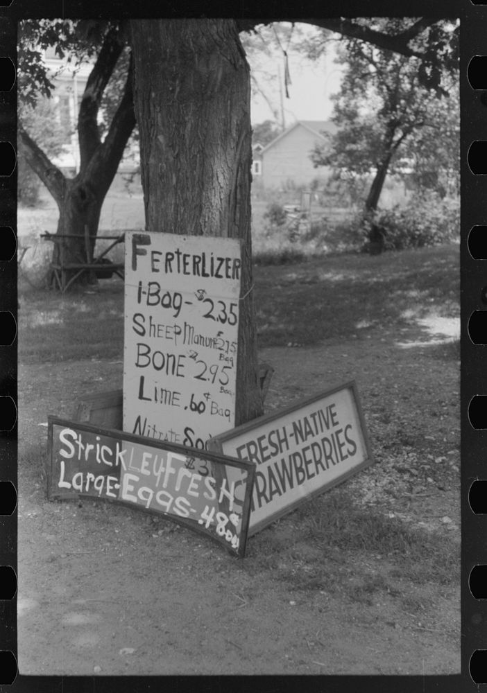 Signs in front of private home, evidence of boom town and crowded housing conditions. Hartford, Connecticut. Sourced from…