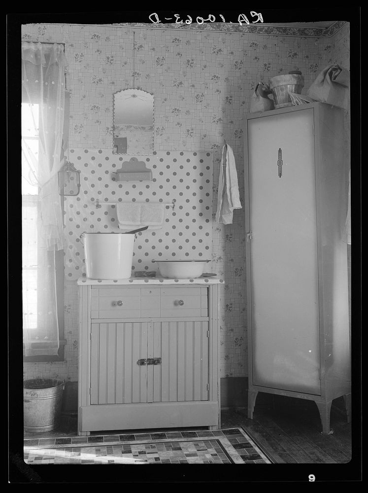 Washstand in house occupied by married hired hand and his wife. Harry Madsen farm near Dickens, Iowa. Three hundred sixty…