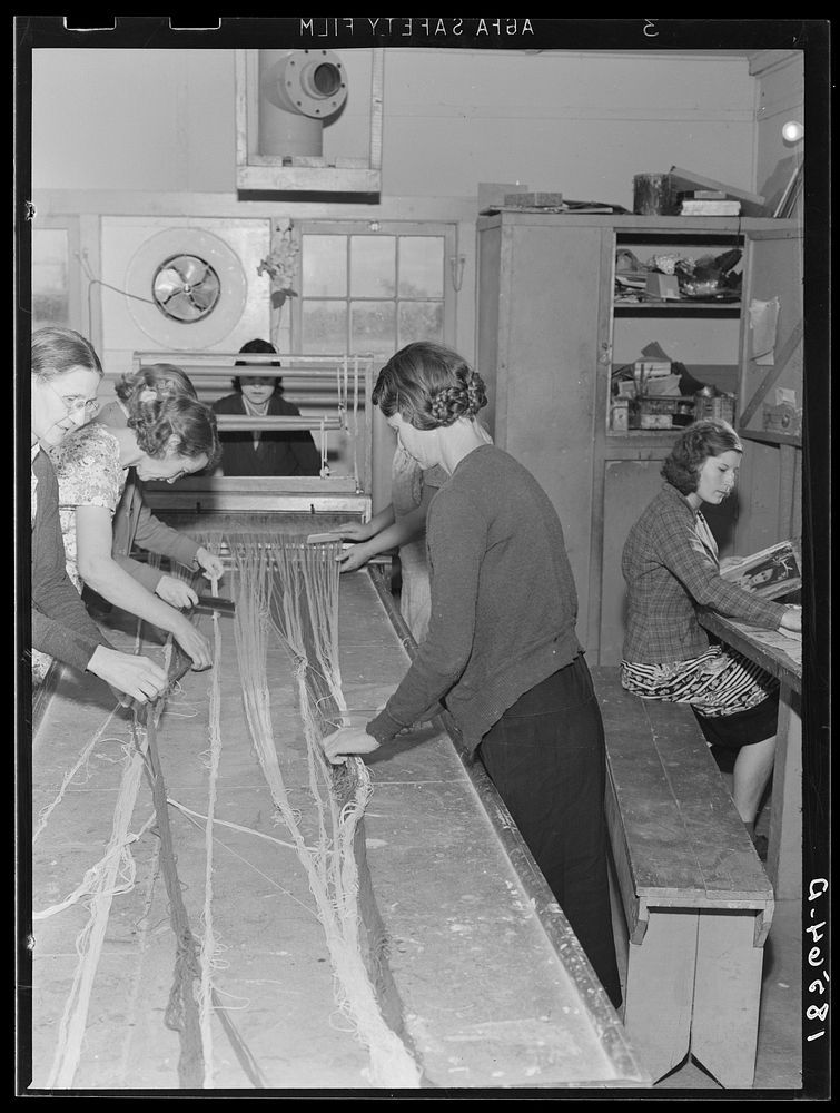 [Untitled photo, possibly related to: In the sewing room, migrant women are instructed in rug-making. Shafter camp for…