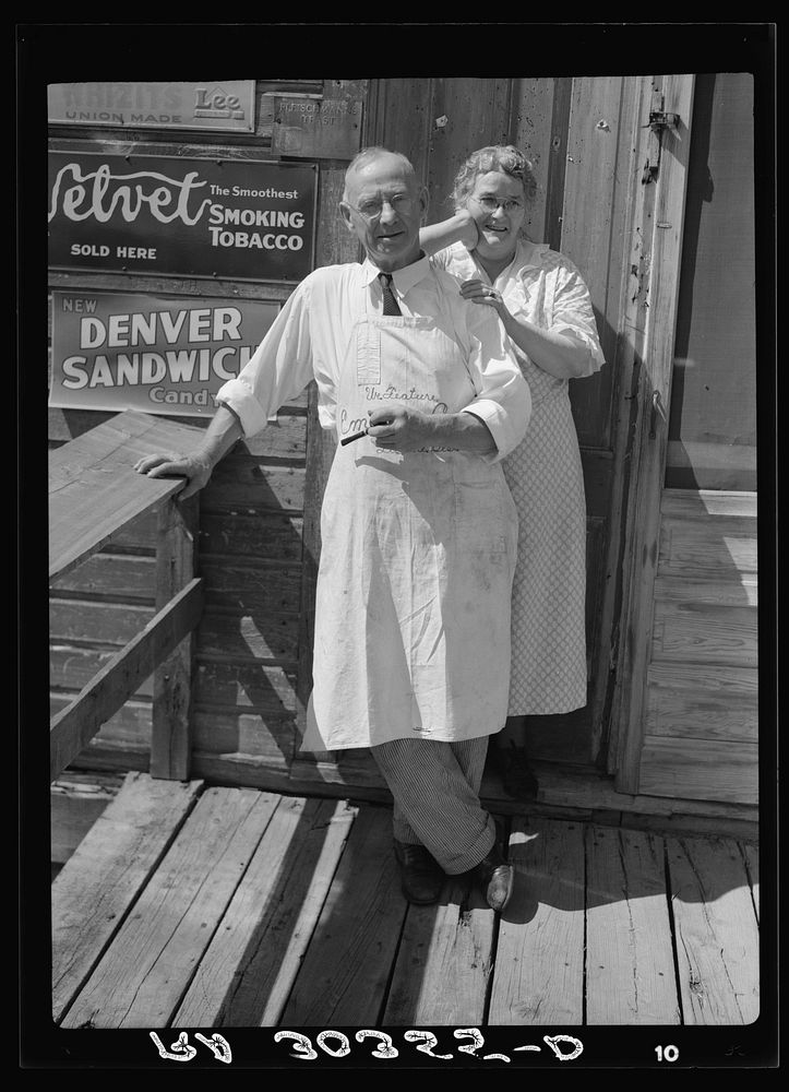 Storekeeper and his wife in front of their store at section 30. "Bust" iron mining town near Winton, Minnesota by Russell Lee