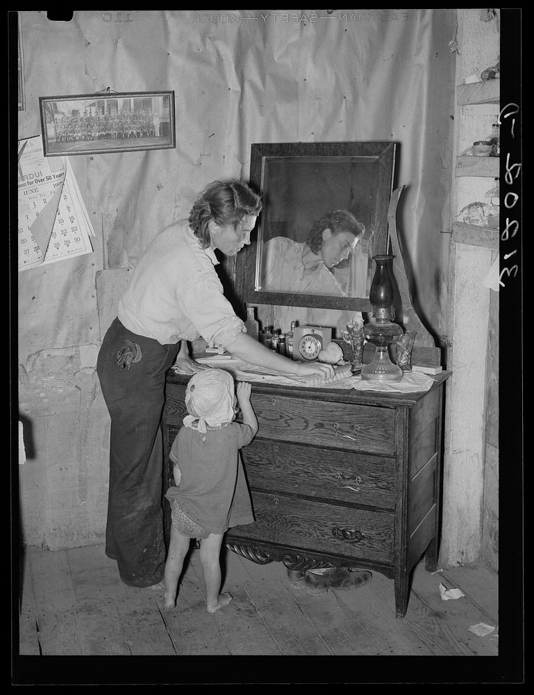 Southeast Missouri Farms. Mother and child in bedroom of sharecropper home by Russell Lee
