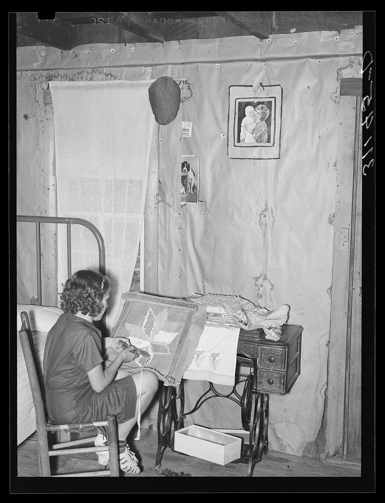 Southeast Missouri Farms. Girl making a hooked rug in bedroom of shack home. La Forge, Missouri by Russell Lee