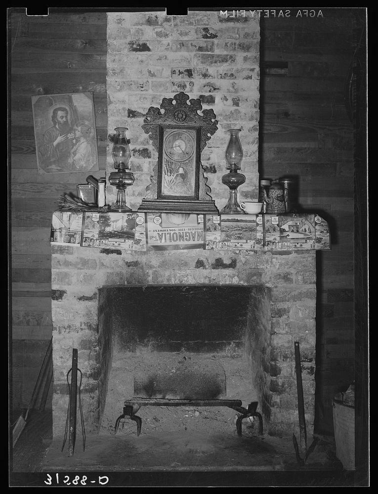 Fireplace in home of aged couple living twenty miles south of Crowley, Louisiana by Russell Lee