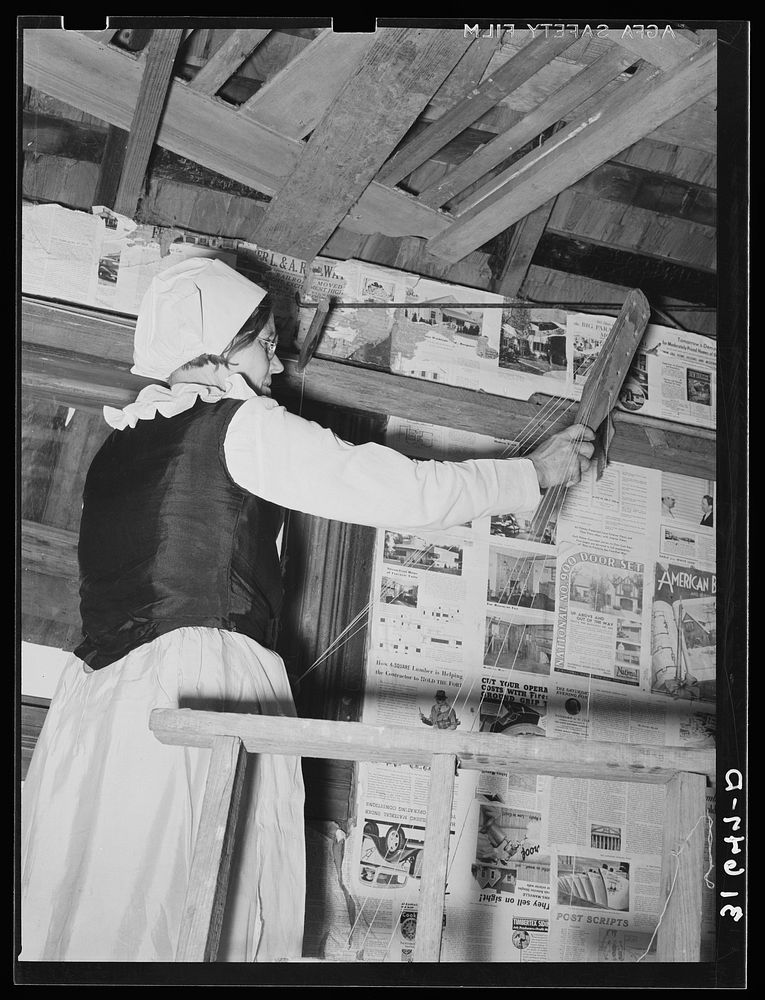 Madame Dronet using shuttle in making the warp of homespun material. Erath, Louisiana by Russell Lee